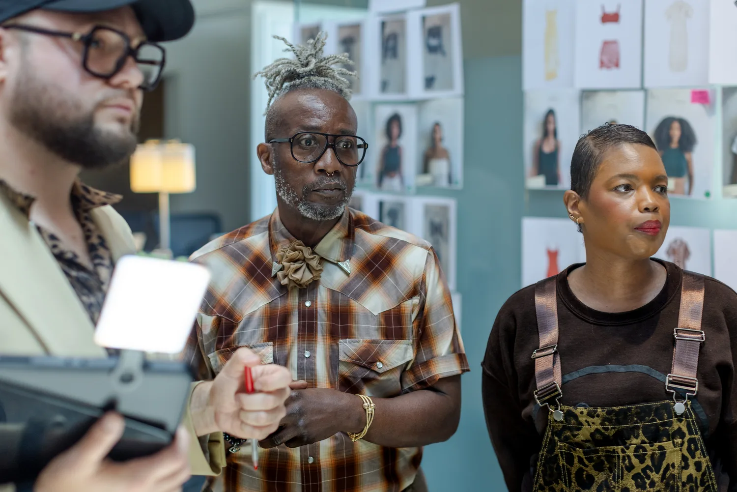 The team reviewing looks against the casting board