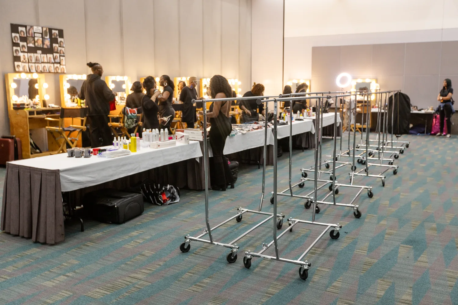 Backstage glam stations and garment racks before the show